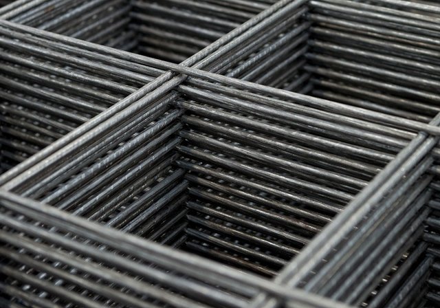 Stacked sheets of welded reinforcing mesh